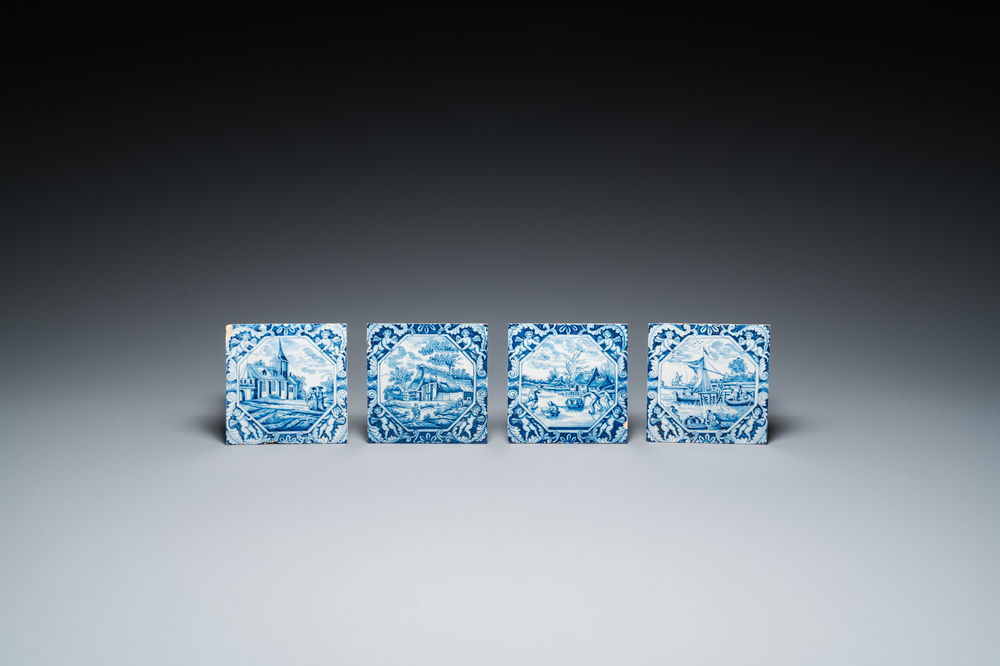 Four blue and white Dutch Delft tiles with fine landscapes and cherubs as corner motives, 18th C.