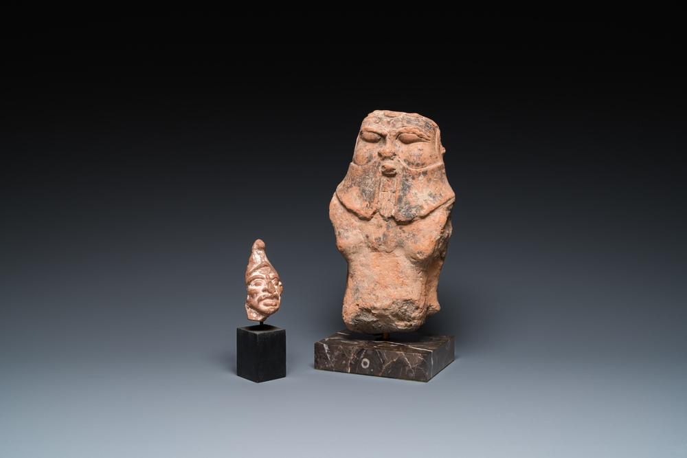 Een Romeinse terracotta sculptuur van de god Bes en een grotesk mannenhoofdje, ca. 1e eeuw