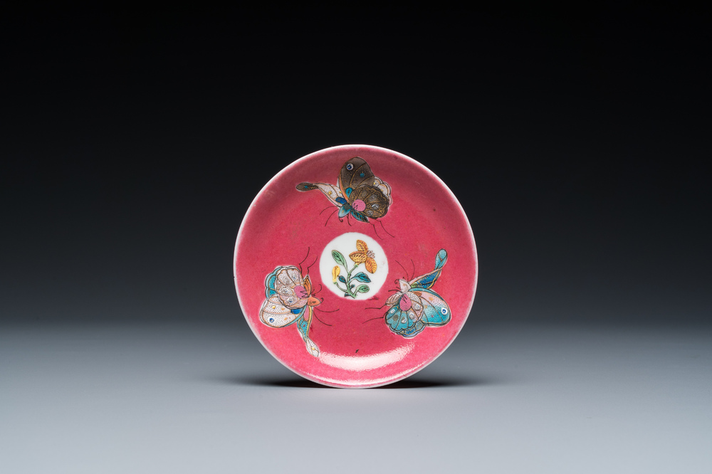 A rare Chinese famille rose ruby-ground 'three butterflies' saucer, Yongzheng