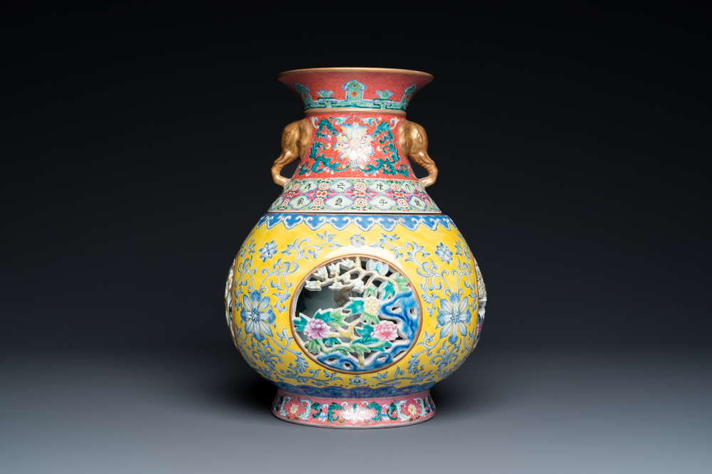 A Chinese reticulated and revolving famille rose vase consisting of two parts, Qianlong mark, 20th C.