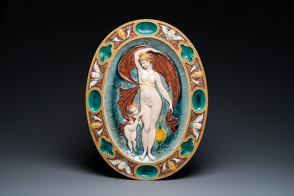 An oval Mintons majolica dish with a goddess with putto, England, year mark 1874