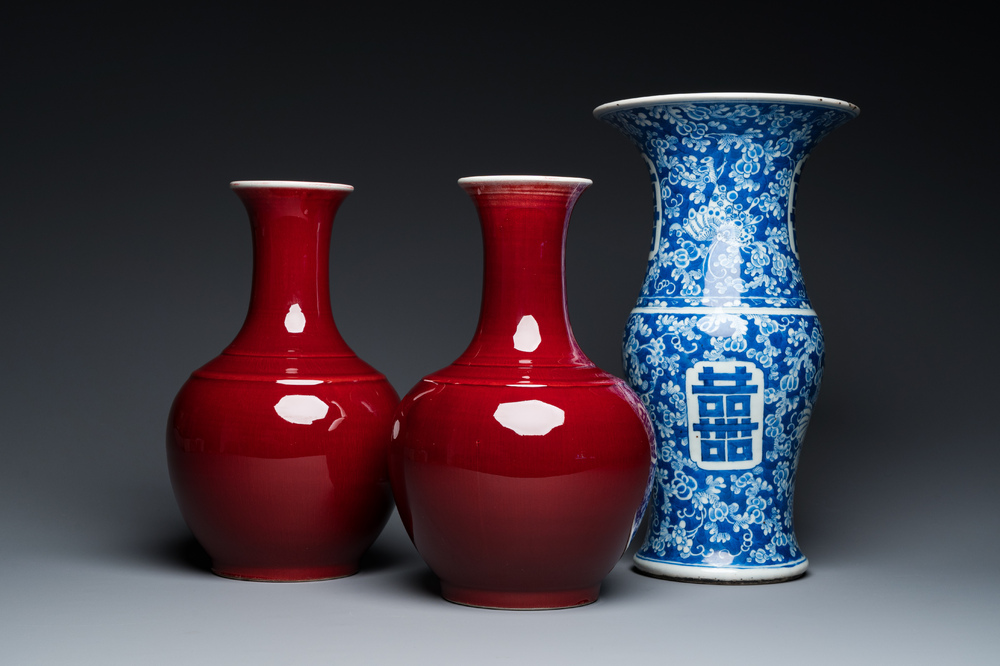 A Chinese blue and white 'Shou' vase with butterflies and a pair of sang-de-boeuf-glazed bottle vases, 19/20th C.