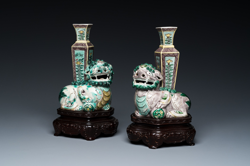 A pair of Chinese verte biscuit vases resting on Buddhist lions, Kangxi