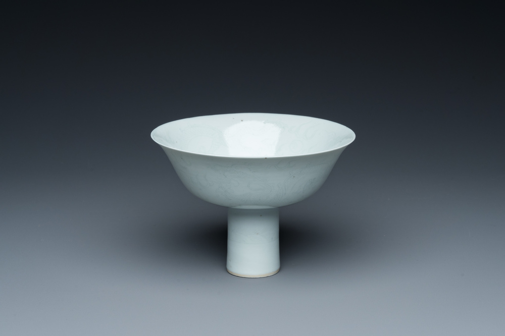 A Chinese monochrome white-glazed stem cup with anhua dragon design, Qianlong mark, 18/19th C.