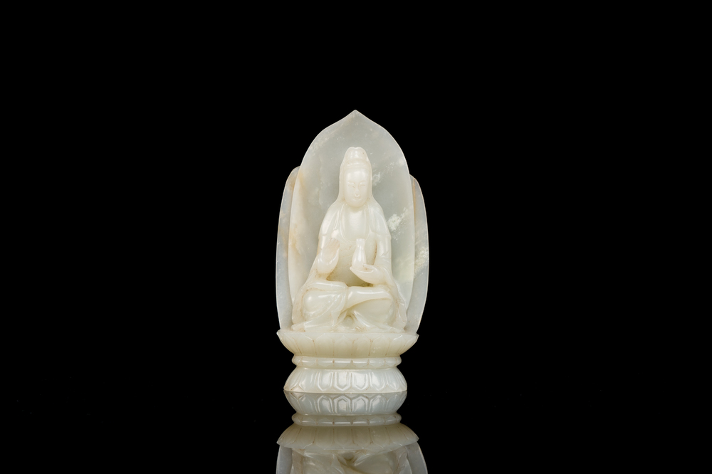 A Chinese white jade sculpture of Guanyin on a lotus throne, Qing