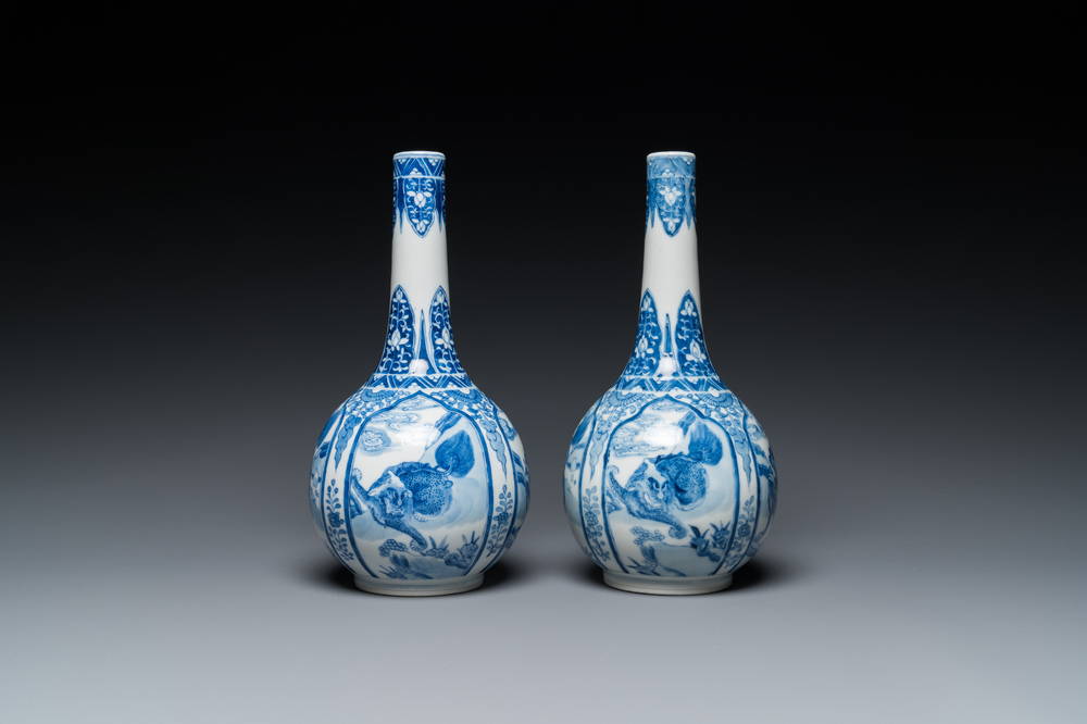 A pair of Chinese blue and white bottle vases with mythical animals, 19th C.