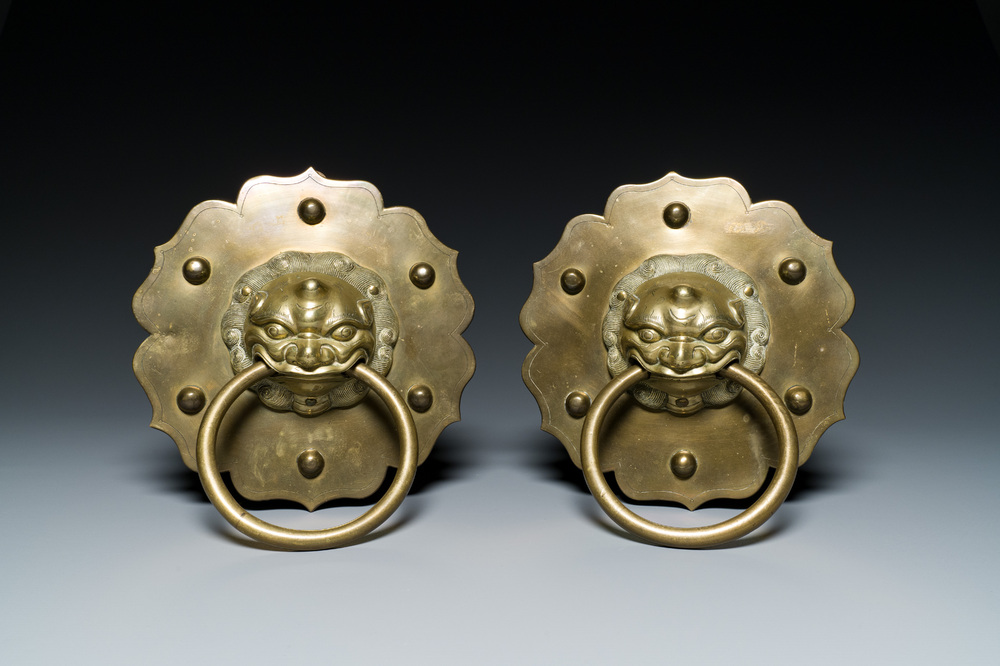 A pair of Chinese brass door knockers with lion heads, 19th C.