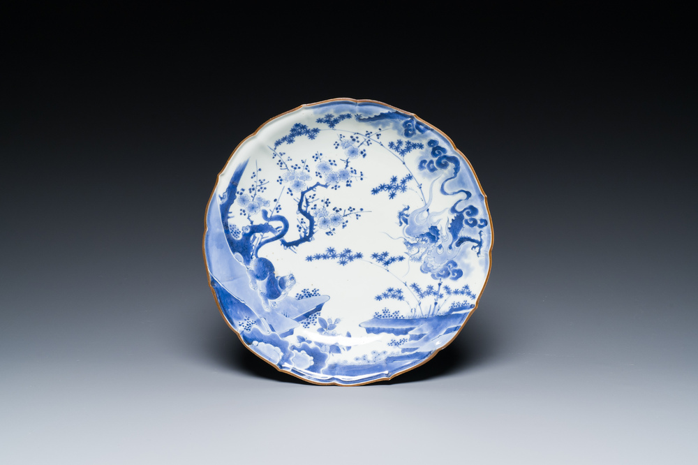 A Japanese blue and white Arita dish with a tiger and a dragon in Kakiemon-style, Fuku mark, Edo, late 17th C.