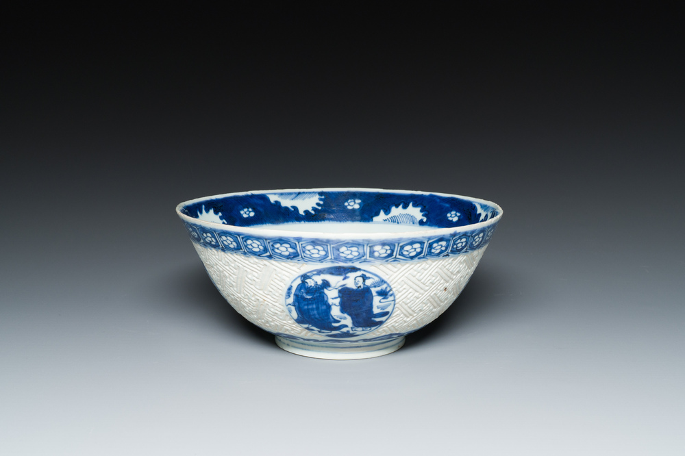 A Chinese blue and white 'Shou Lao' bowl with carved exterior, Chenghua mark, Wanli