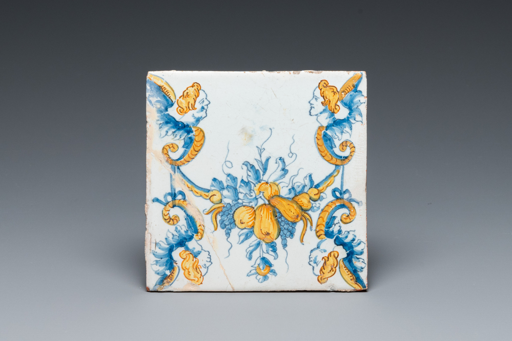 An extremely rare polychrome Dutch Delft tile with garlands and mascarons, 17th C.