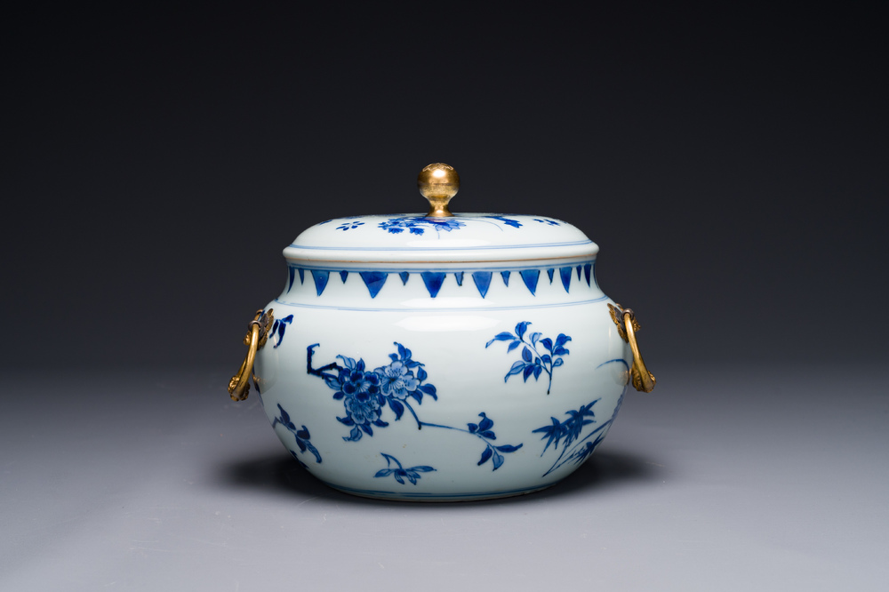 A Chinese blue and white covered bowl with floral design and gilt ...