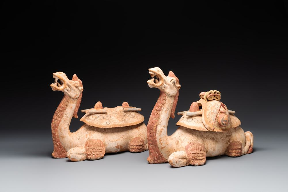 A pair of Chinese polychrome-painted terracotta camels with saddles, Tang