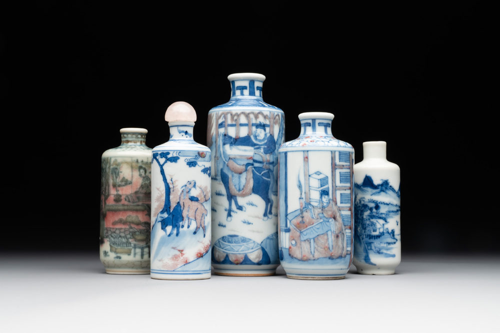 Four Chinese blue, white and copper-red snuff bottles and a blue and white snuff bottle, 19/20th C.