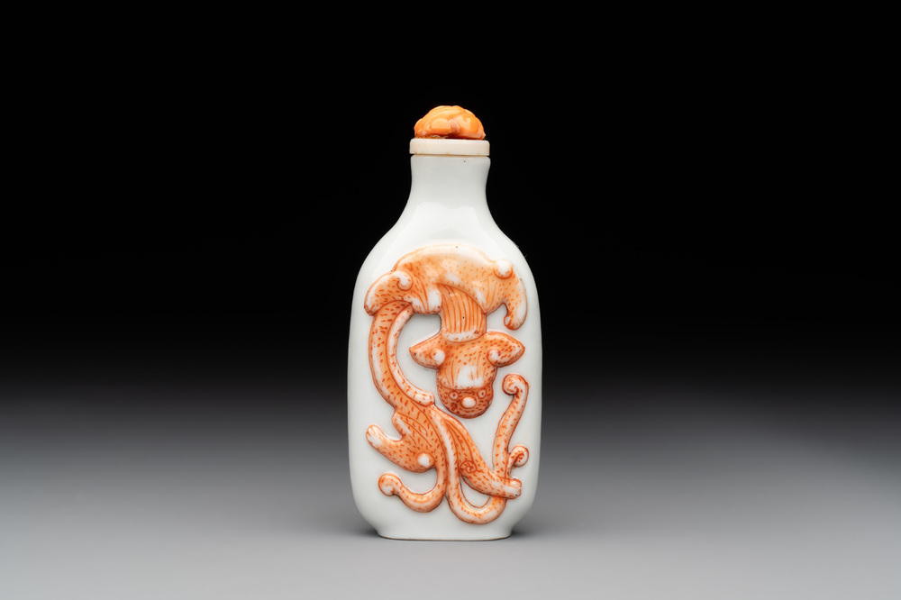 A Chinese moulded iron-red 'chilong' snuff bottle, 19th C.