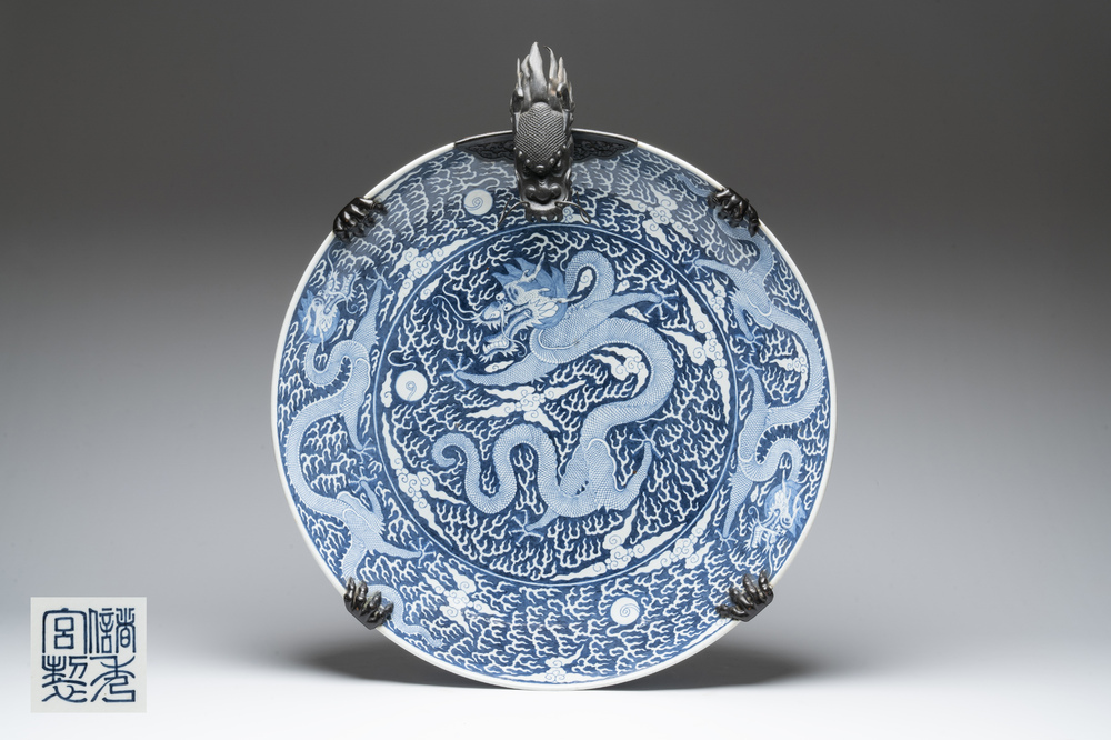 A massive Chinese blue and white reverse-decorated  'dragon' charger with bronze mounts, Chuxiu Gong Zhi mark, Guangxu