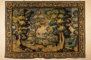 A Flemish wall tapestry with a forest view with a castle, 17th C.