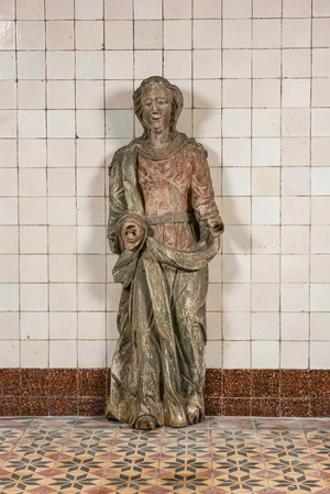 A large polychrome wooden sculpture of a female saint, early 17th C.