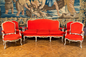 A partly gilt wooden sofa and four armchairs with red velvet upholstery, 18/19th C.