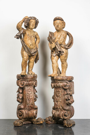 A pair of large polychrome wooden allegorical putti on bases, probably Italy, 18th C.