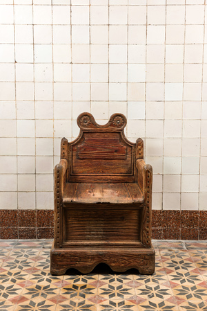 A wooden armchair with inner compartment, 19th C.