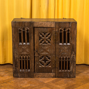 An English Gothic-style carved oak hanging cupboard composed of old elements, 17th C. and later