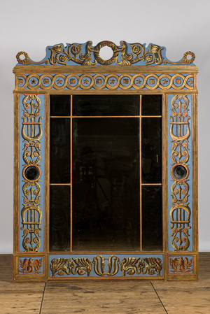 An imposing richly decorated polychrome wooden mirror, 20th C.