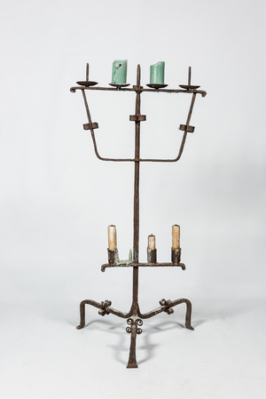 A large wrought iron candlestick, 15th C. or later