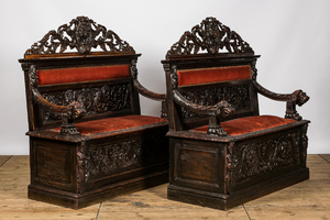 A pair of richly carved wooden hall benches, 19th C.