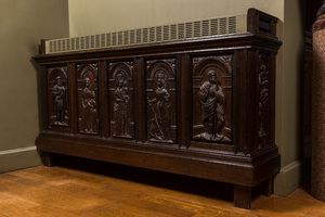 A carved oak panel with saints mounted as a heating frame, 19/20th C.