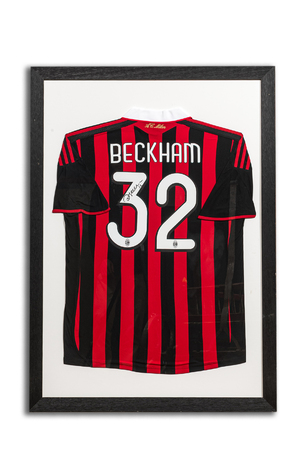 A framed and A.C. Milan football jersey signed by David Beckham